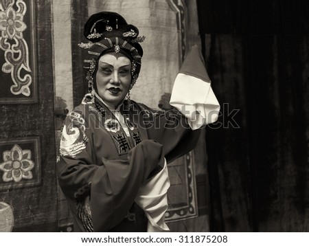 SINGAPORE - AUG 20: Dark sepia version of an elderly Chinese Teochew opera singer perform on Aug 20, 2015 in SINGAPORE.