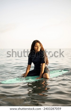 Similar – Image, Stock Photo Female athlete in wetsuit on calm lake shore