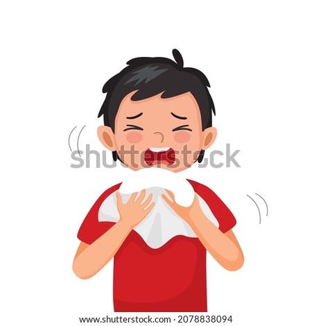 Cute little boy suffering from flu or cold allergy symptom sneezing on a handkerchief or tissue paper.