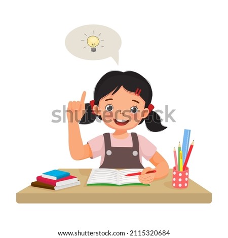 Cute little girl have an idea to solve the problems in math homework raising her index finger pointing up while sitting studying on the desk at home Foto stock © 