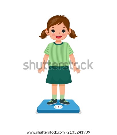 cute happy little girl child standing on the weighing scale checking her weight Foto d'archivio © 