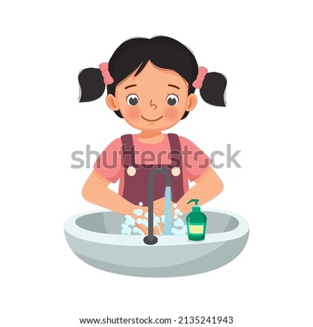 cute young girl washing hands with antibacterial soap and running water under faucet at the sink as prevention against Virus and Infection and personal hygiene