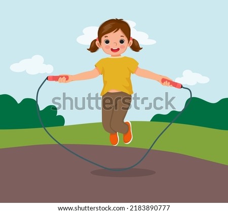 cute little girl skipping jumping rope at the park