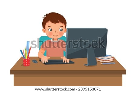 Cute little boy student study using Computer PC at the desk