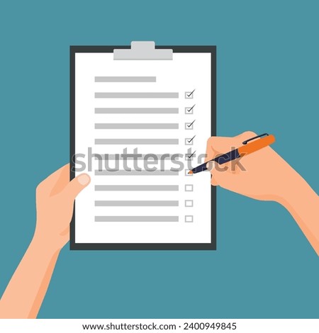 Hand holding clipboard and pen with checklist making mark on to do list