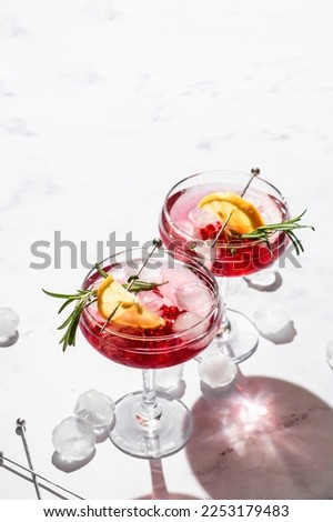 Similar – Image, Stock Photo Glass of pomegranate margarita with flower blooms near near feathers