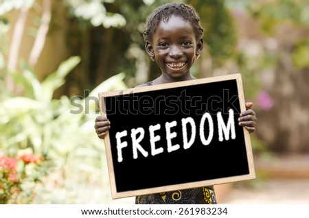 Freedom - African Girl Holding Chalkboard. An African girl holding a blackboard.