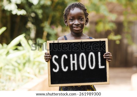 School And Education - African Girl Holding Chalkboard. An African girl holding a blackboard.