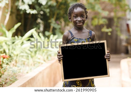 Copy Space for your text - African Girl Holding Blackboard. An African girl holding a blackboard, with plenty of copy space.