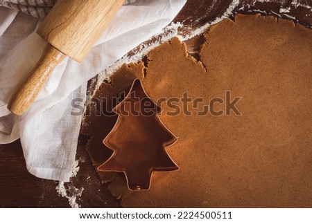 Similar – Image, Stock Photo Gingerbread cookies dough cut in different shapes on a blue table. Baking Christmas cookies