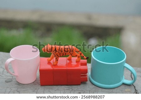 Similar – Image, Stock Photo two plastic cups with liquor stand on a wooden table