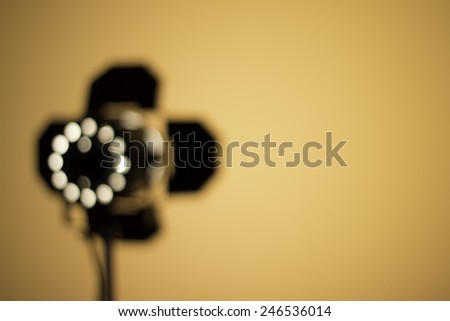 Blurry location spot light, small lamp and wall