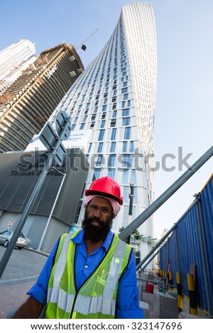 DUBAI - NOVEMBER 16: Dubai construction worker near Cayan Tower, Dubai Marina on November 16, 2014 in Dubai