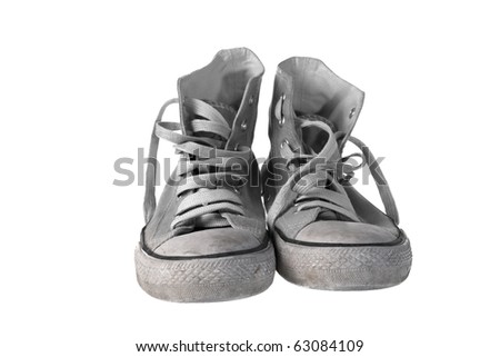 Pair of old and dirty sneakers , isolated on white