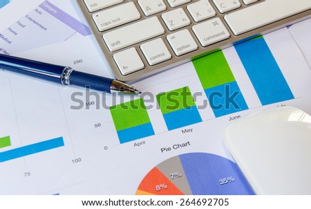 keyboard and pen on finance report