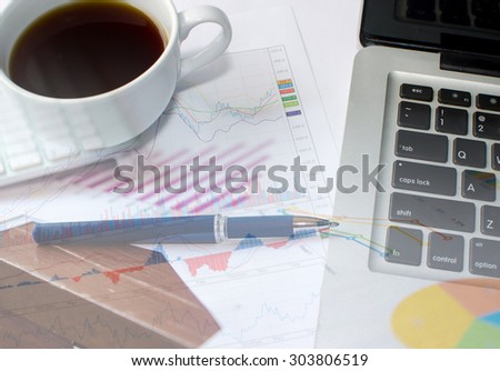 paper chart and computer on table