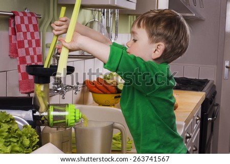 Little boy making green juice