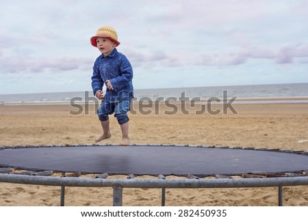 little boy jumping on a trampoline