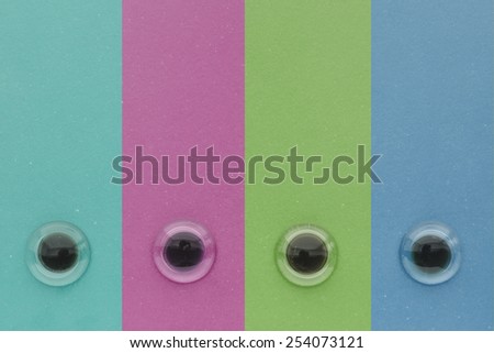 Color vertical stripes with eyes like glass pebbles background