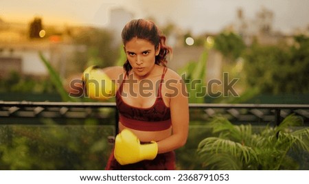Similar – Image, Stock Photo Serious sportswoman with boxer braids posing with crossed arms