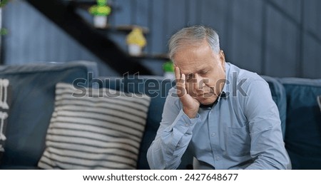 Similar – Image, Stock Photo Pensive senior male sitting on floor with cup of tea