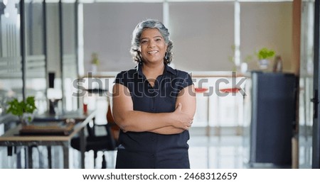 Similar – Image, Stock Photo An older woman is sitting on the sofa with a book. She is typing on her phone while smiling. She is protecting herself and staying home. Pandemic concept.