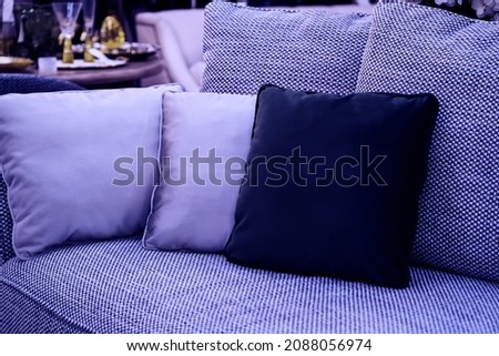 image toned in pantone color of the year 2022 very peri. cushions on cozy violet sofa. Pillows on casual couch in the living room