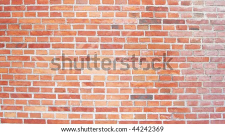Large section of an old brick wall with different brick pattern layers