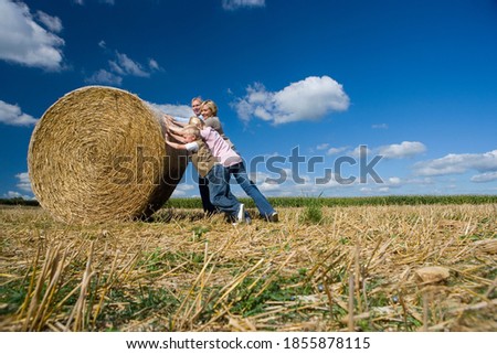 Similar – Image, Stock Photo Woman Pushing Hay Bale