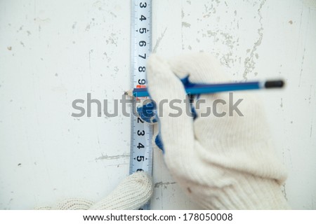 Repairs in the apartment. measuring wall with tape measure