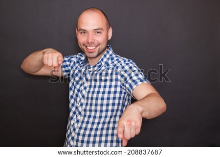 Man pointing his fingers at you , isolated on black background