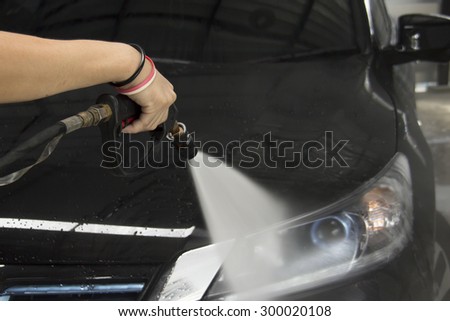 cleaning a car by high pressure water