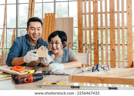 Similar – Image, Stock Photo Male woodworker teaching son in workshop