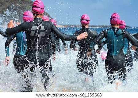 Similar – Image, Stock Photo Female athlete in wetsuit on calm lake shore