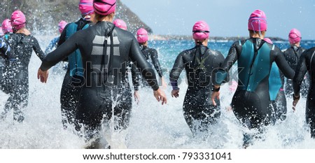 Similar – Image, Stock Photo Female athlete in wetsuit on calm lake shore