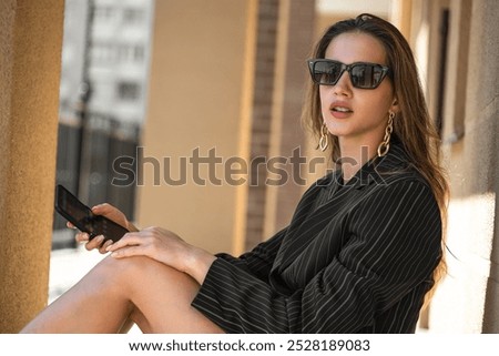 Similar – Image, Stock Photo Trendy businesswoman and sunglasses leaning behind bus