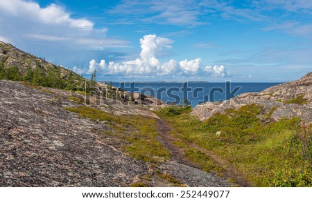 View of rocks of the archipelago of Kuzova,sea, blue sky, clouds. Kuzova archipelago located in the north of Russia in the White Sea to the east of of Kem.