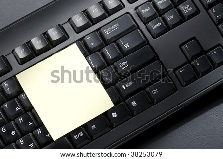 Post-it attached on black keyboard