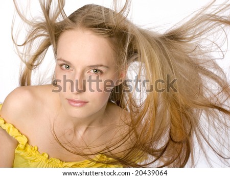 Face shot of gorgeous blond model with hair blowing in the wind.
