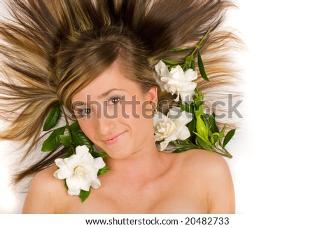 Gorgeous brunette face shot with gardenia flowers