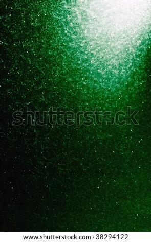 Winter holiday background from snowfall on a green window