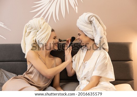 Girls touching each other faces with mascara brush ストックフォト © 