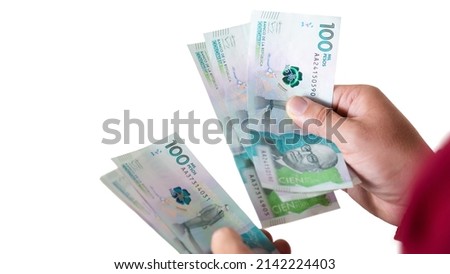 latin man counting colombian money , red sack, businessman or entrepreneur on white background Foto stock © 