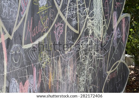 Chalkboard scribbles in many colors and forms at a local park