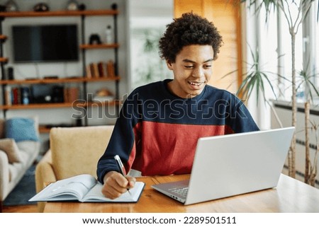 Similar – Image, Stock Photo Student learning at home. Young woman making notes, reading and learning from notepad