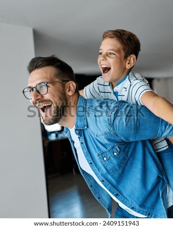 Similar – Image, Stock Photo Father and son playing in the park at the sunset time.