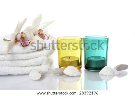 well being concept with towel, candle and plants on white background