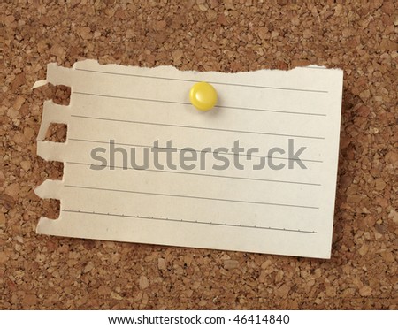 closeup of note paper  on cork board