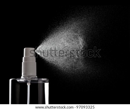 close up of  a spray bottle drops on black background