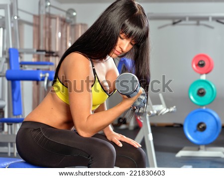 Beautiful woman doing exercises in a sport club.